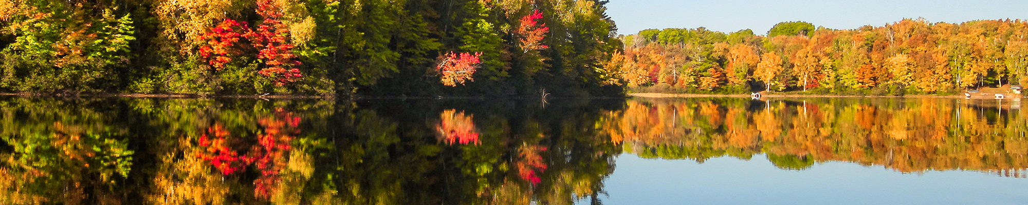 Lake in Fall surrounded by trees with leaves turning colors