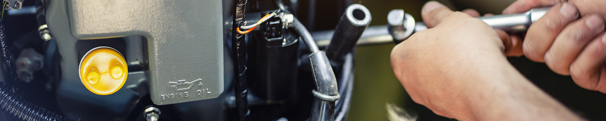 Marine mechanic working on a boat motor